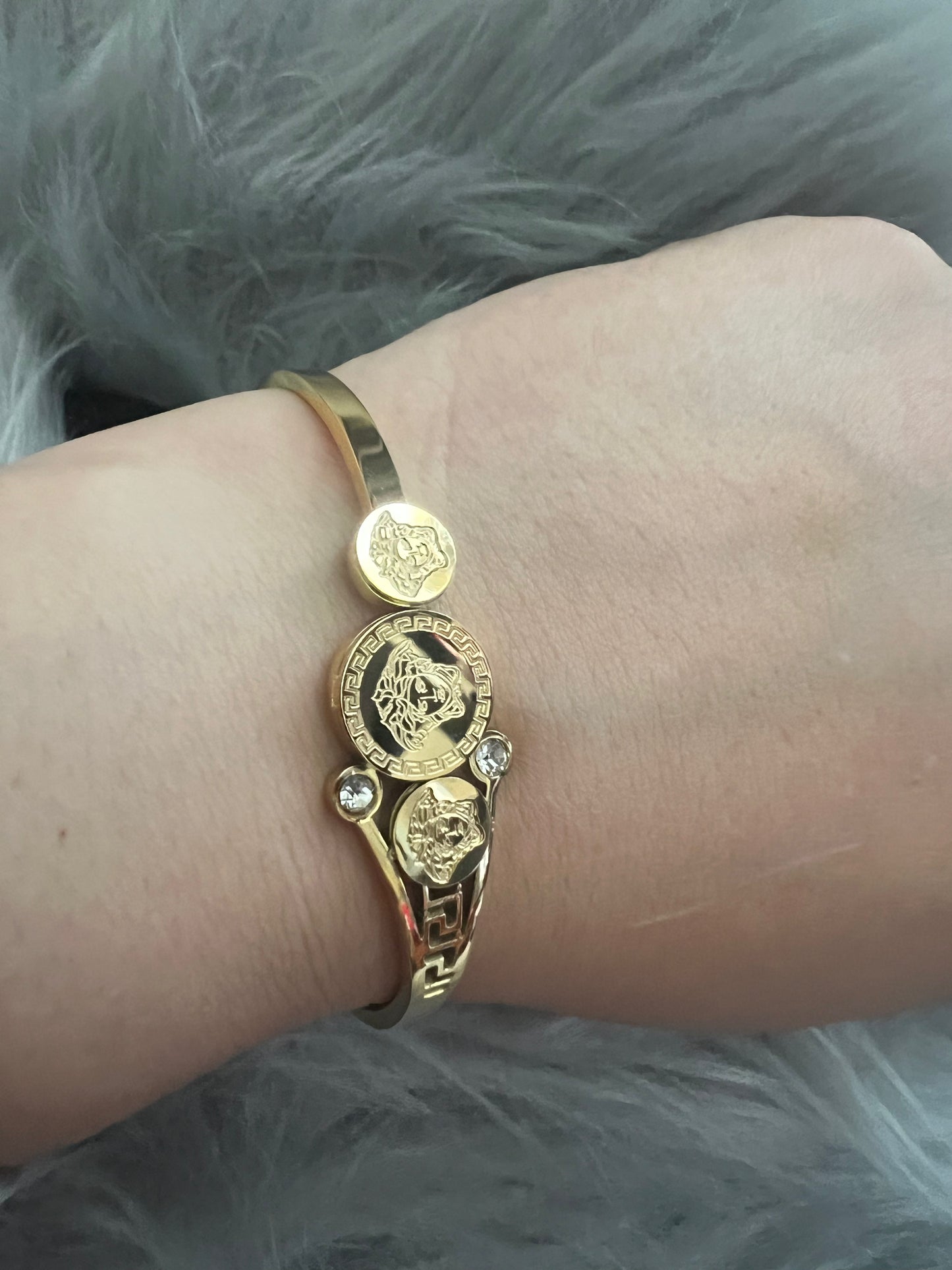 Elegant Gold-Tone Bangle with Embedded Stones